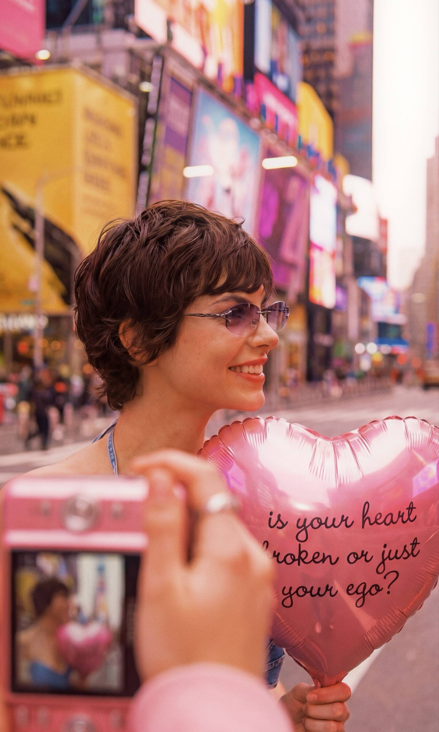 AI editorial shot with phone foreground and pink heart balloon